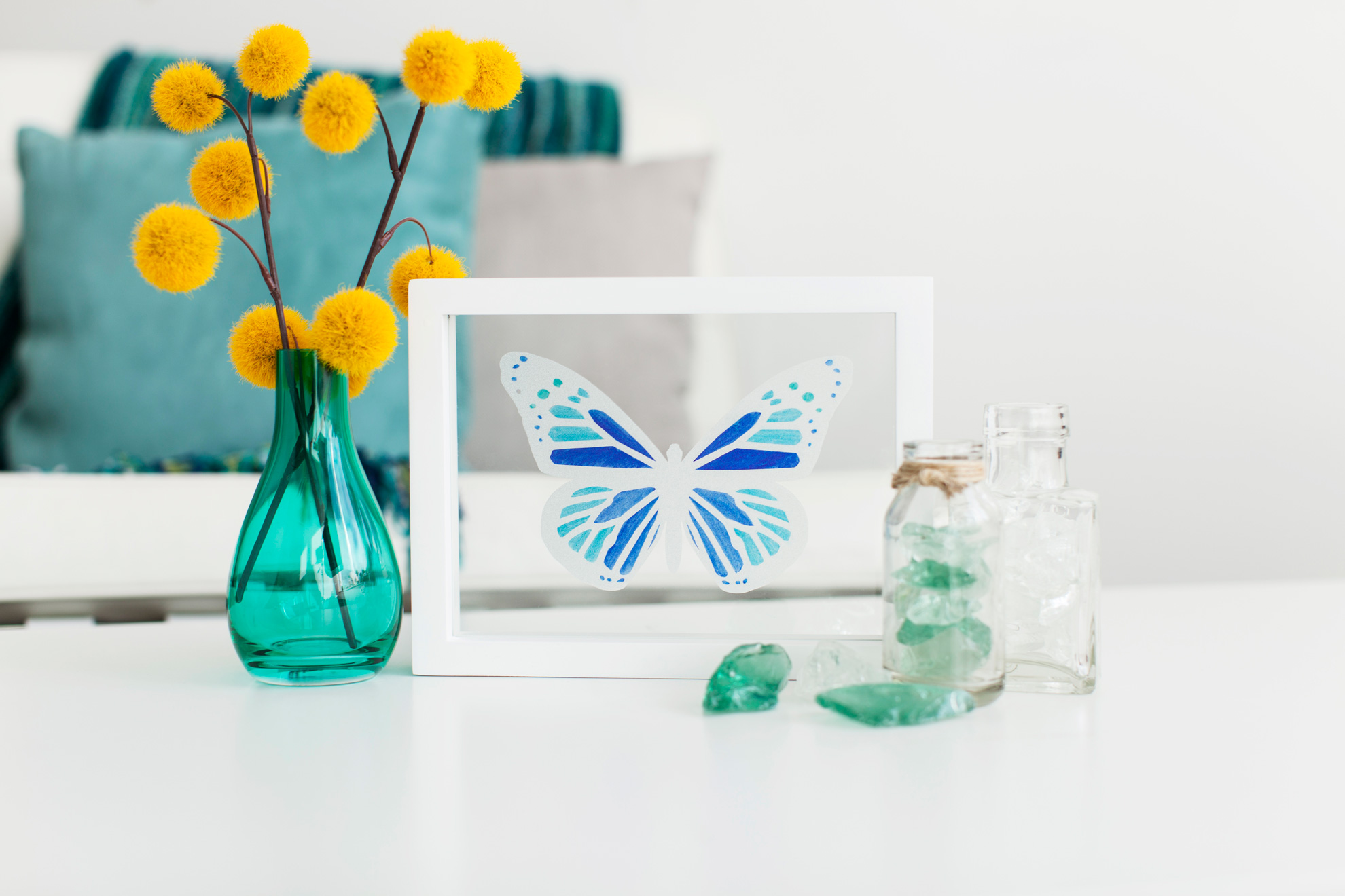 butterfly design inside white frame on table