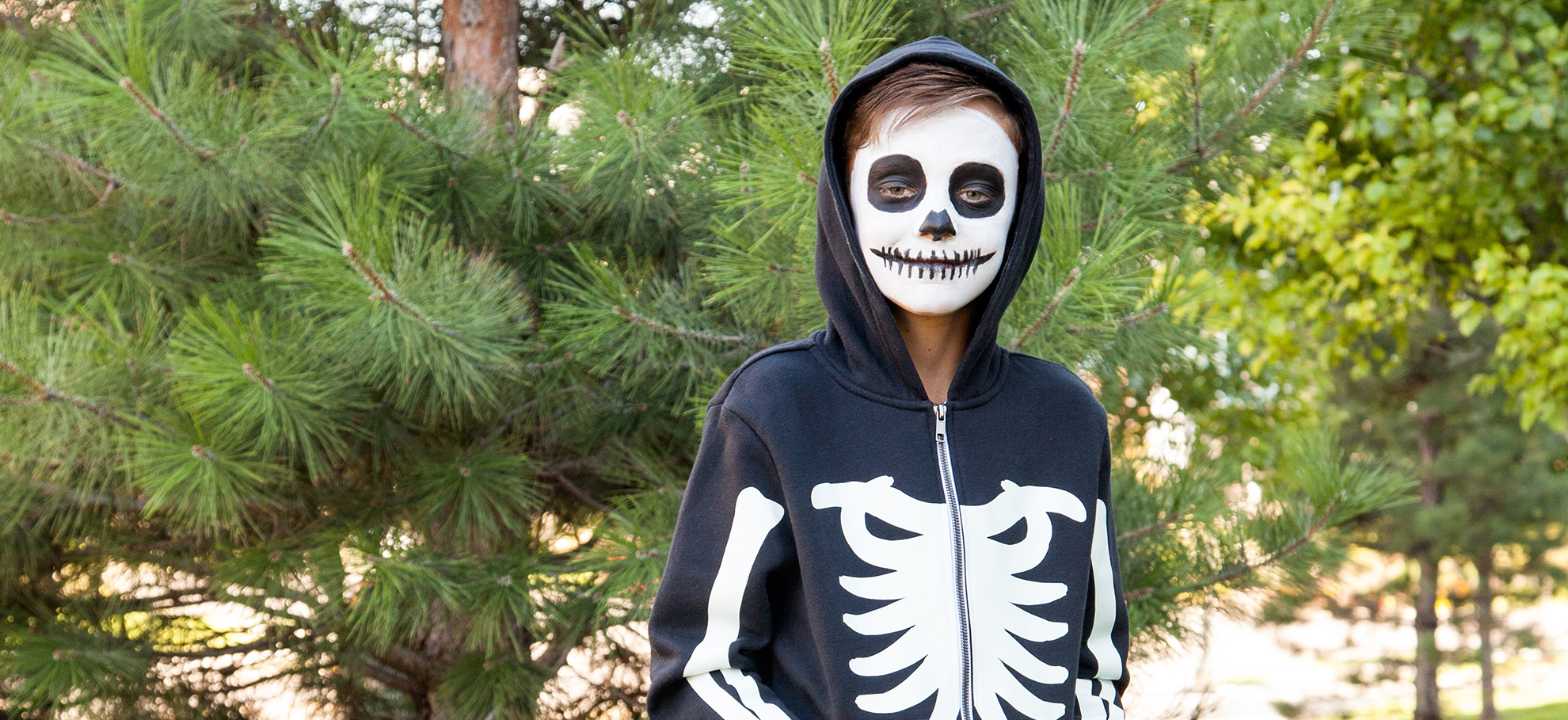 young boy wearing skeleton costume