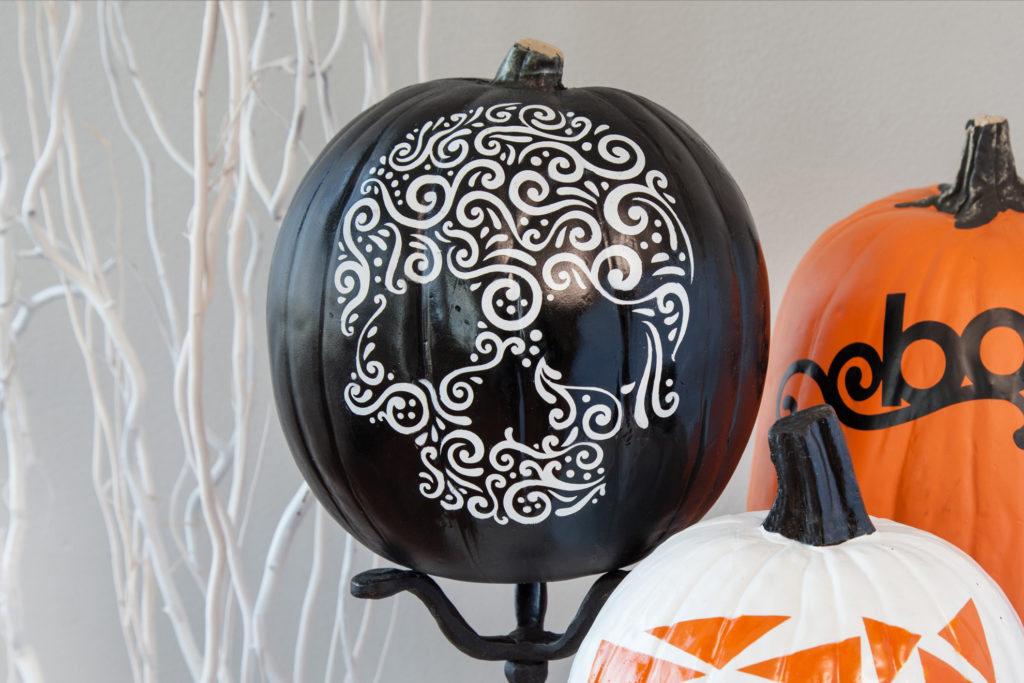 Black pumpkin with white skull design